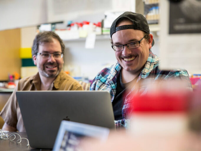 Michael-Kay-candid-106-682×532 a couple of students working on a laptop in a lab