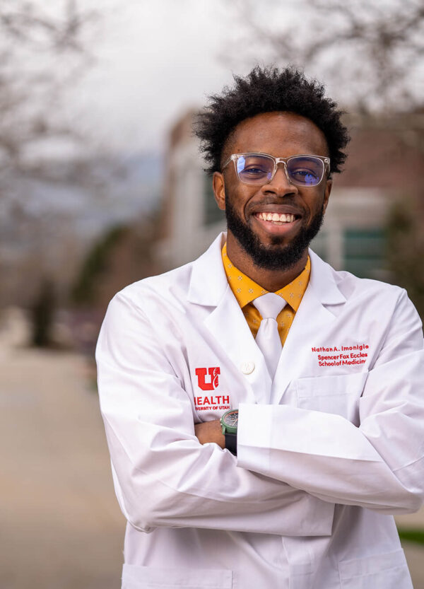 Student-Scholarship-UMFA-27_2000-600×833 a smiling student with a lab coat