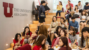 a crowd of students in an orientation session at the Utah Asia Campus