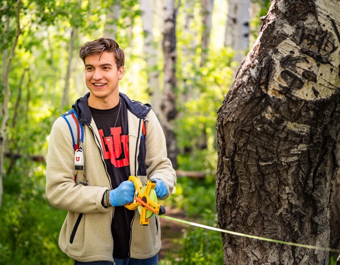 05-dreaming-Utah-Fresh-forest-178-682×532 a student in the woods with a measuring device