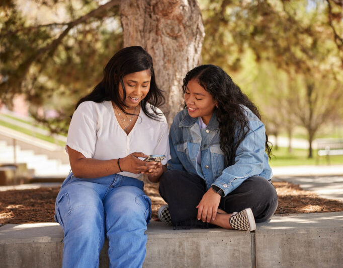 20210504_UofU_4641_2000-682×532 one person shows another something on their phone