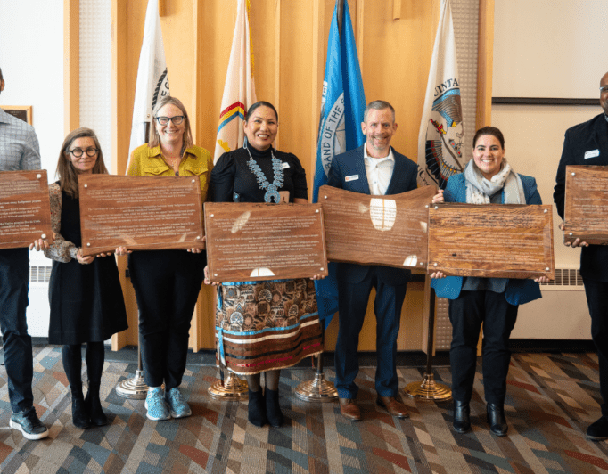 Native-American-Heritage-Month-2023-682×532 a group of people pose with plaques that are ready to hang up