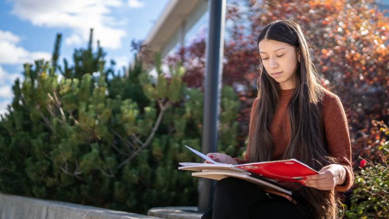 a student does homework outside between classes