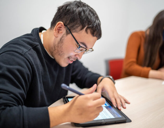 TRIO-Tutoring-4-682×532 someone working on a tablet