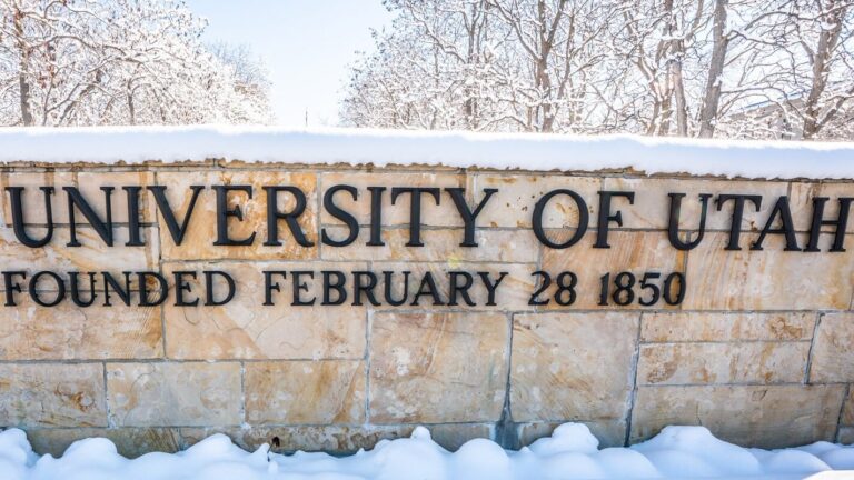 the front sign of the University of Utah in the winter