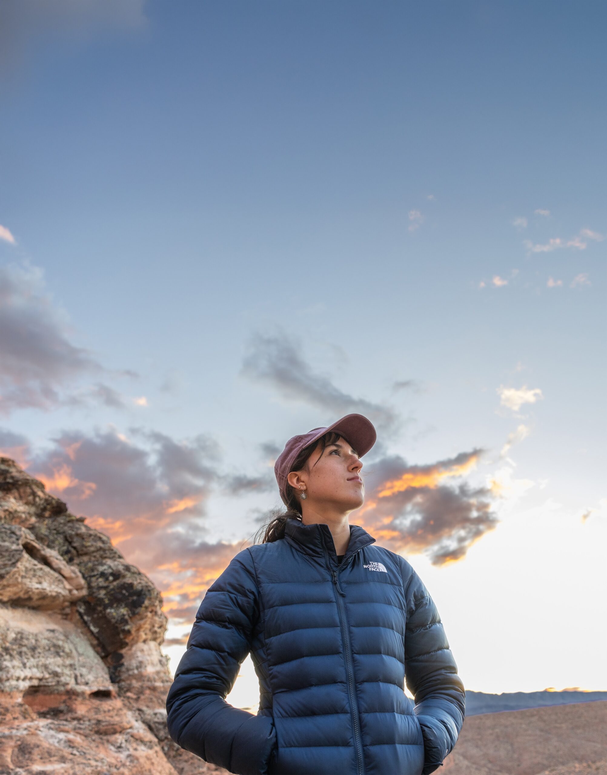 a portrait of a student in the outdoors, with a wide sunset sky behind them